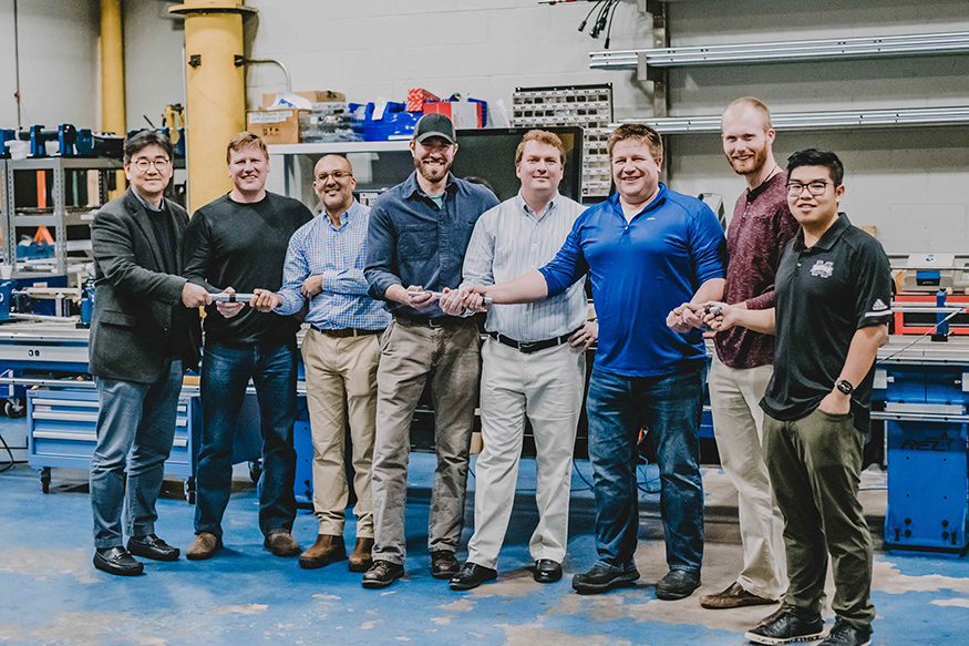 Mississippi State and REL personnel hold the MSU-developed serpentine bar technology