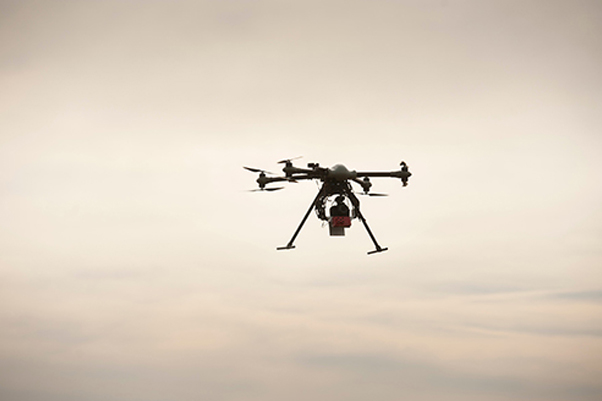 A flying drone among clouds