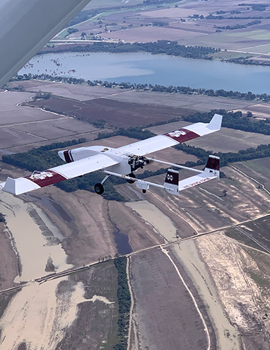 The TigerShark XP3 UAS platform gathering data along the banks of the Mississippi River