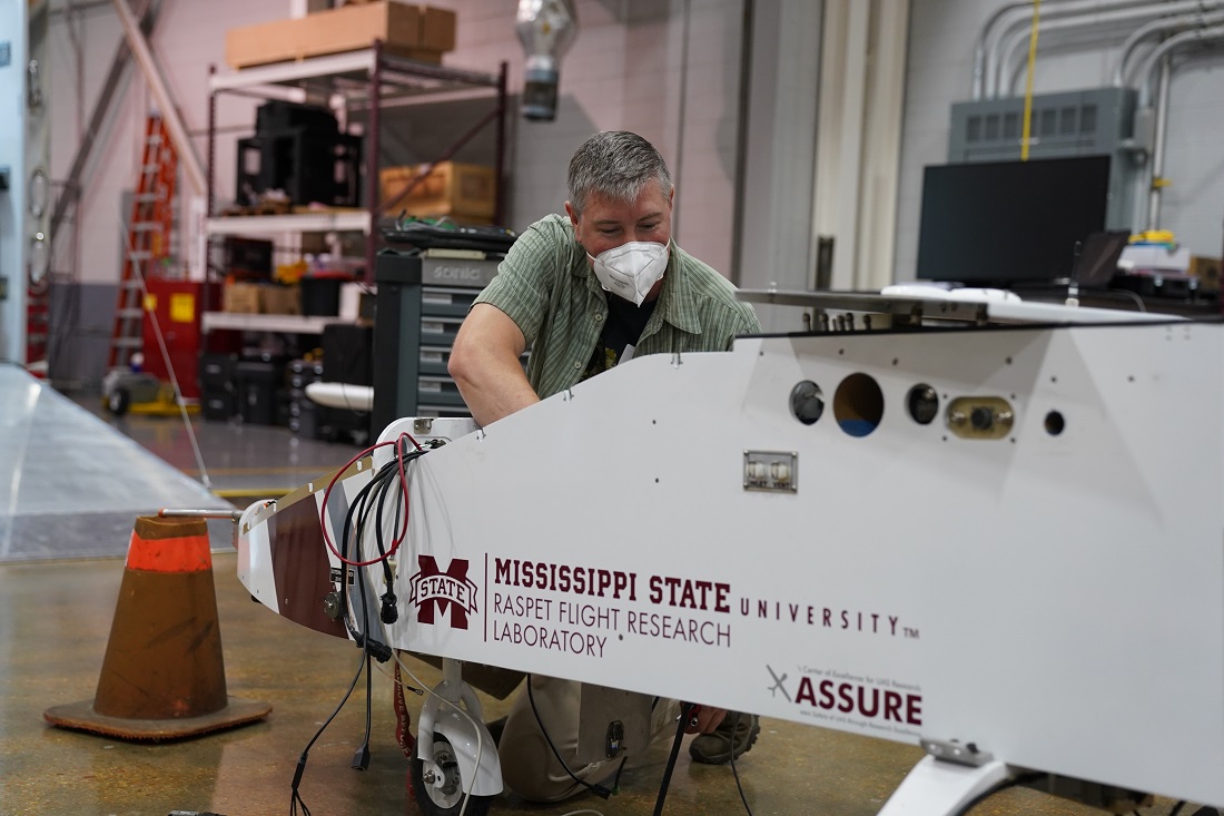 ARM's Matt Newburn works to integrate instrumentation into a Mississippi State University Raspet Flight Research Laboratory TigerShark XP