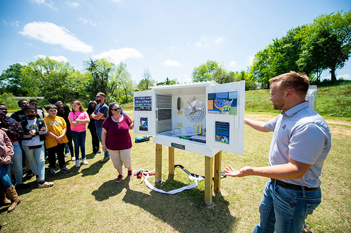 Researching showing students how the new weather station is used 