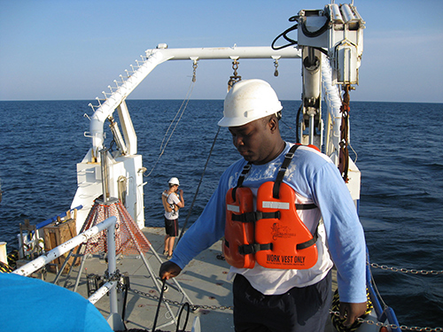Ebenezer Nyadjro conducting research aboard a ship