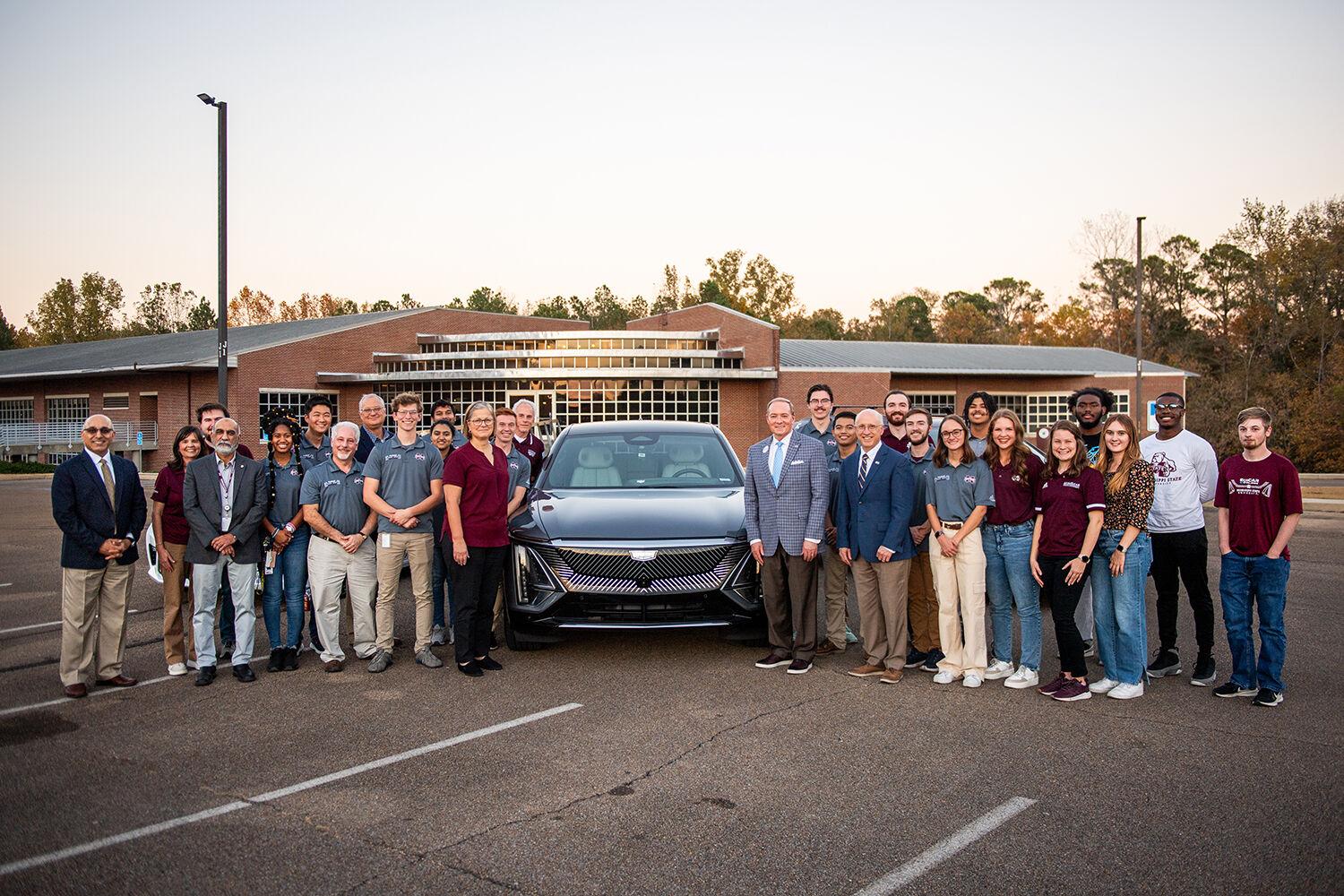 MSU President Mark E. Keenum and Provost David Shaw, center right, along with Vice President for Research and Economic Development Julie Jorden, left of car, are pictured with MSU's student EcoCAR Electric Vehicle Challenge team members, along with faculty advisors who will help guide the team during the prominent four-year competition to implement an all-electric powertrain and other cutting-edge features in a new Cadillac LYRIQ. The program develops students to become leaders in the automotive and related engineering fields. Photo by Grace Cockrell. 