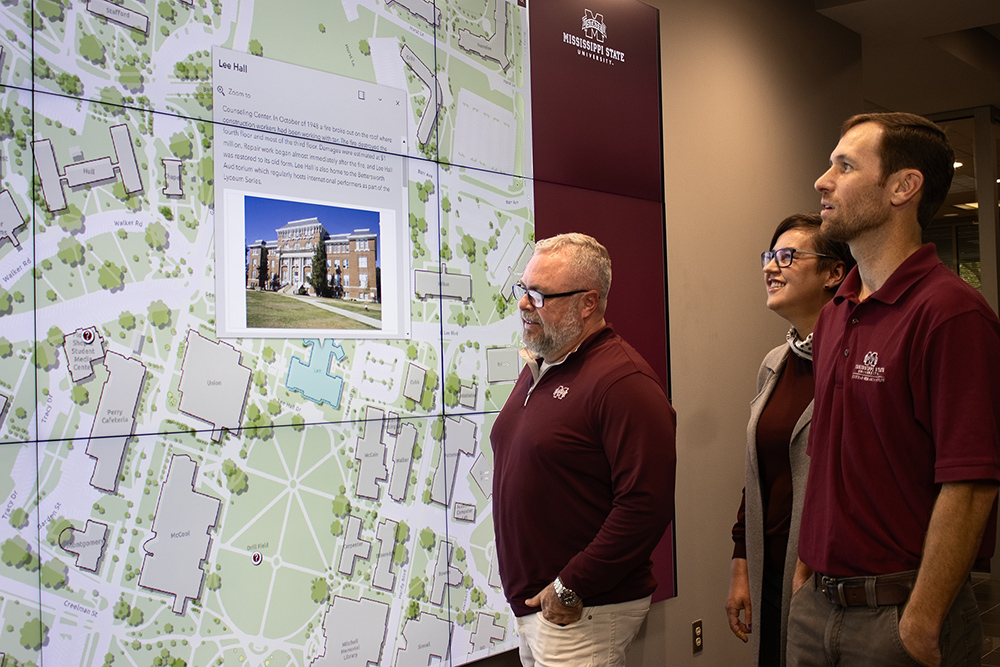 MSU Geosystems Research Institute Assistant Extension Professor John Cartwright, front, along with GRI Research Associate Kate Grala and GRI GIS Coordinator Andrew Nagel view the new interactive campus map built by the researchers. 