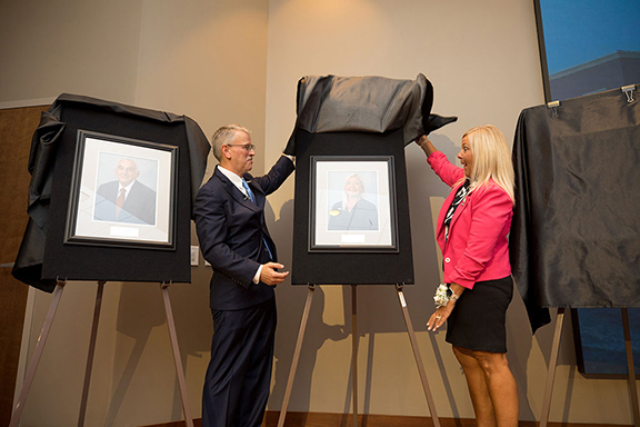 David Pittman, U.S. Army Engineer Research and Development Center director, and Patti Duett, associate director for MSU's Institute for Systems Engineering Research (ISER), unveil her induction photo for the U.S. Army Corps of Engineers Waterways Experiment Station Gallery of Distinguished Civilian Employees. Photo submitted.