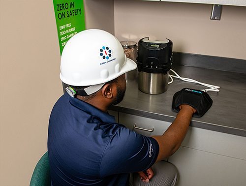 An Ingalls Shipbuilding employee demonstrates the CoolMitt device used in a new partnership between MSU, Ingalls and CoolMitt to aid shipbuilders in the mitigation of heat injuries. (Photo courtesy of Ingalls Shipbuilding)