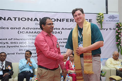 George Banzhaf greeted by conference host