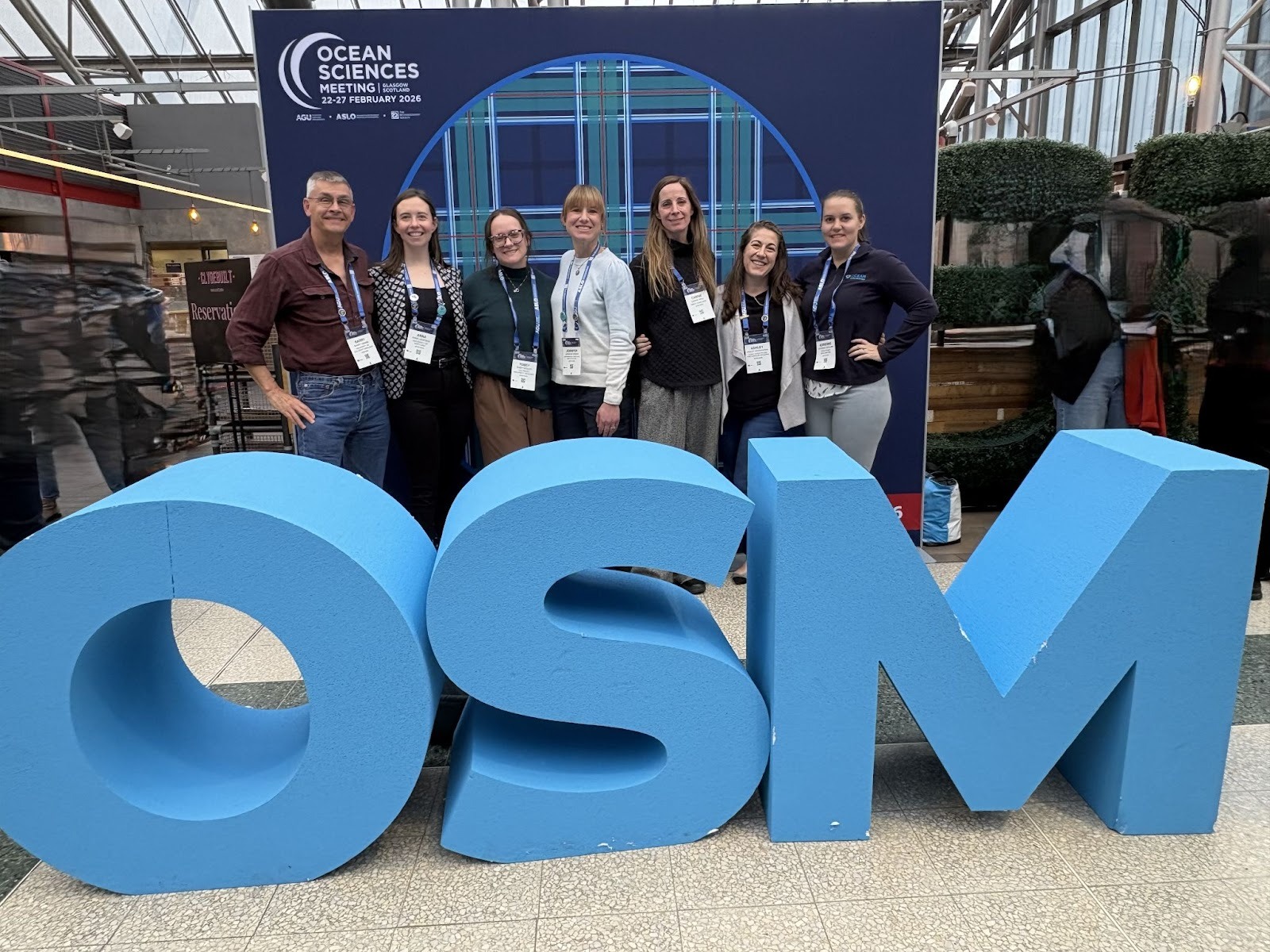 Jennifer Green and collogues at OSM sign