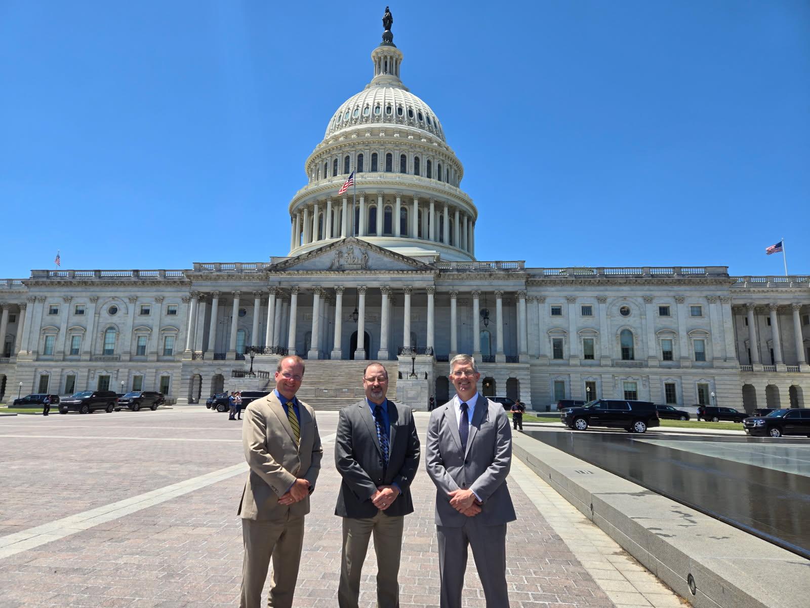 Men in front of the capitol building